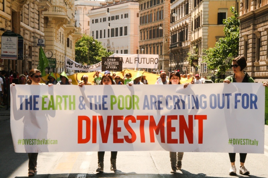 the earth and the poor are crying out for divestment - climate march Vatican